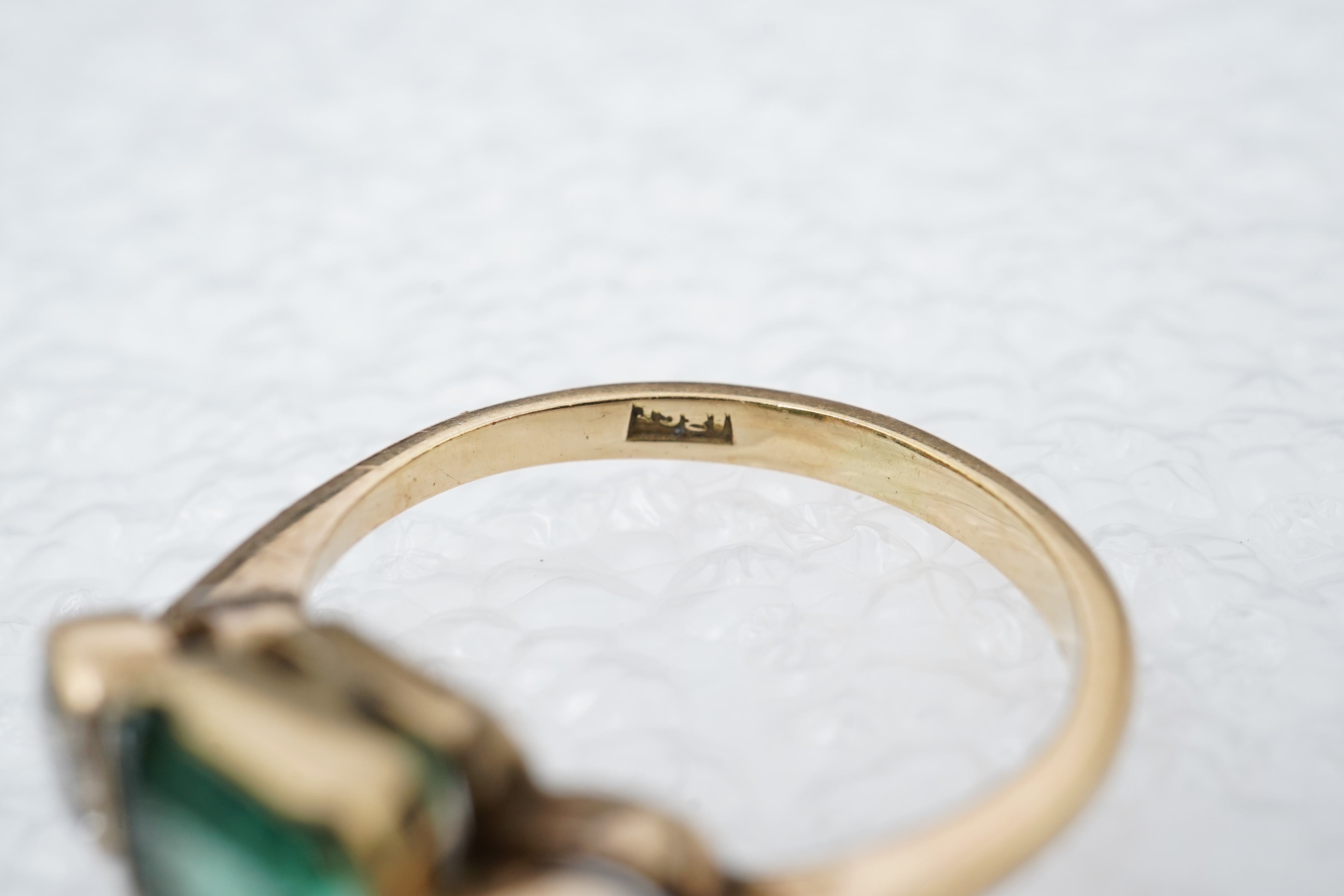 An emerald and diamond ring